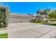 Spacious home featuring a three car garage, solar panels, and a well-manicured front yard at 4881 S Vista Pl, Chandler, AZ 85248