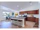 Modern kitchen featuring a kitchen island, wooden cabinets, and stainless steel appliances at 4881 S Vista Pl, Chandler, AZ 85248