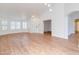 Bright, open-concept living room with wood flooring, ample natural light, and stylish light fixtures at 4881 S Vista Pl, Chandler, AZ 85248