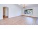 Light-filled living room featuring wood floors, a stylish chandelier, and windows offering scenic views of a tranquil lake at 4881 S Vista Pl, Chandler, AZ 85248