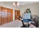 Bright bedroom with closet, ceiling fan, and blue armoire at 5421 E Michelle Dr, Scottsdale, AZ 85254