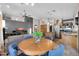 Dining table with blue upholstered chairs and a living room in the background at 5421 E Michelle Dr, Scottsdale, AZ 85254