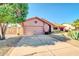 Single-story home boasts desert landscaping, a two-car garage, and a welcoming, well-maintained exterior at 5421 E Michelle Dr, Scottsdale, AZ 85254