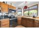 Well-lit kitchen with wooden cabinets, modern appliances, and a cozy rug at 5421 E Michelle Dr, Scottsdale, AZ 85254