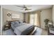 Well-lit bedroom features a ceiling fan, bedside tables, and a decorative painting above the bed at 6310 E Avalon Dr, Scottsdale, AZ 85251