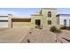 Two-story home boasts desert landscaping, a two-car garage, and an arched front entry at 6310 E Avalon Dr, Scottsdale, AZ 85251