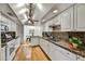 Bright kitchen featuring granite counters, white cabinets, stainless steel sink, and hardwood floors at 6310 E Avalon Dr, Scottsdale, AZ 85251