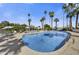 Large community pool is surrounded by tall palm trees, lounge chairs and shade umbrellas at 6310 E Avalon Dr, Scottsdale, AZ 85251