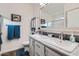 Well-lit bathroom with double sinks, a large mirror, and a separate shower area at 650 N Hawes Rd -- # 3217, Mesa, AZ 85207