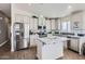 Modern kitchen with white cabinets, stainless steel appliances, and center island with marble countertop at 650 N Hawes Rd -- # 3217, Mesa, AZ 85207