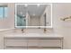 Beautiful bathroom with illuminated mirror, gold faucets, and tiled shower visible in the mirror at 6802 N 22Nd Pl, Phoenix, AZ 85016