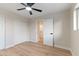 Bright bedroom with wood-look tile flooring, ceiling fan, and closet at 6802 N 22Nd Pl, Phoenix, AZ 85016