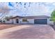 Well-maintained house with a two-car garage and a tidy front yard under a bright, cloudy sky at 6802 N 22Nd Pl, Phoenix, AZ 85016