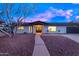 Attractive home exterior with a welcoming front entrance, lush landscaping, and a two-car garage at 6802 N 22Nd Pl, Phoenix, AZ 85016