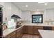 Well-lit kitchen featuring quartz countertops, custom cabinetry, and stainless steel appliances, perfect for cooking enthusiasts at 6802 N 22Nd Pl, Phoenix, AZ 85016