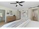 Bright main bedroom with modern ceiling fan, stylish artwork, and closet access to the main bathroom at 6802 N 22Nd Pl, Phoenix, AZ 85016