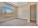 Cozy bedroom with carpet flooring, large window, and a glimpse into the ensuite bathroom at 7210 E Camino Rayo De Luz --, Scottsdale, AZ 85266