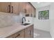 Modern laundry room boasts ample cabinet space, counter, and a window for natural light at 8336 N 72Nd Pl, Scottsdale, AZ 85258