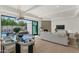 Living room view to the outdoor pool and patio area with a fireplace at 8336 N 72Nd Pl, Scottsdale, AZ 85258