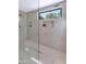 Contemporary glass shower with window and built-in shelving at 8336 N 72Nd Pl, Scottsdale, AZ 85258