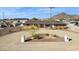 Aerial view of a charming desert home surrounded by a circular driveway, a single palm tree, and desert landscape at 9120 W Villa Lindo Dr, Peoria, AZ 85383