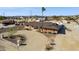 Aerial view of a charming desert home surrounded by a circular driveway, a single palm tree, and desert landscape at 9120 W Villa Lindo Dr, Peoria, AZ 85383