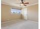 Neutral bedroom featuring a ceiling fan, window, and plush carpet at 9120 W Villa Lindo Dr, Peoria, AZ 85383