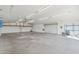 Spacious garage interior with high ceilings, roll-up door, ample lighting, and concrete floors, ready for customization at 9120 W Villa Lindo Dr, Peoria, AZ 85383