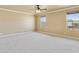 Spacious main bedroom has neutral paint, carpet, and a ceiling fan at 9120 W Villa Lindo Dr, Peoria, AZ 85383