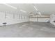 Spacious outbuilding interior with concrete floors and utility shelving at 9120 W Villa Lindo Dr, Peoria, AZ 85383