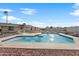 Lush backyard featuring a pool, a well-maintained lawn, desert landscaping, and a block fence at 9120 W Villa Lindo Dr, Peoria, AZ 85383