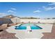 Inviting backyard pool with diving board, complemented by rock landscaping and a privacy fence at 9120 W Villa Lindo Dr, Peoria, AZ 85383