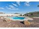 Backyard pool featuring desert landscaping, enclosed by a tall block fence ensuring privacy at 9120 W Villa Lindo Dr, Peoria, AZ 85383