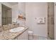 Bright bathroom boasts a granite countertop vanity and tiled walk-in shower at 10222 E Southwind Ln # 1054, Scottsdale, AZ 85262