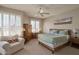 Relaxing bedroom with a comfortable armchair and large windows with plantation shutters at 10222 E Southwind Ln # 1054, Scottsdale, AZ 85262