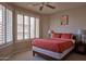 Cozy bedroom features neutral colors, plantation shutters, and ample natural light at 10222 E Southwind Ln # 1054, Scottsdale, AZ 85262