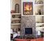 Elegant living room featuring stone fireplace and built-in shelves with decorative items at 10222 E Southwind Ln # 1054, Scottsdale, AZ 85262