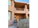 Attractive front door with desert landscaping and second story balcony entrance at 10222 E Southwind Ln # 1054, Scottsdale, AZ 85262