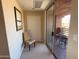 Hallway leading to a balcony with outdoor seating and views of neighboring homes at 10222 E Southwind Ln # 1054, Scottsdale, AZ 85262