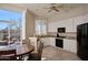 Bright kitchen featuring white cabinets, granite countertops, black appliances and an adjacent breakfast nook at 10222 E Southwind Ln # 1054, Scottsdale, AZ 85262