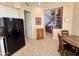 Spacious kitchen with black fridge, wood table, and an open layout flowing to the living area at 10222 E Southwind Ln # 1054, Scottsdale, AZ 85262