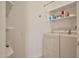 Functional laundry room with modern washer and dryer, overhead shelving, and a bright, clean aesthetic at 10222 E Southwind Ln # 1054, Scottsdale, AZ 85262