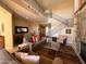 Open living space with staircase, stone fireplace, and views into the dining area at 10222 E Southwind Ln # 1054, Scottsdale, AZ 85262