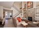 Welcoming living area with a stone fireplace, tall ceilings, staircase, and comfortable sofas at 10222 E Southwind Ln # 1054, Scottsdale, AZ 85262