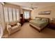 Serene main bedroom with a ceiling fan, plantation shutters, and comfortable furnishings at 10222 E Southwind Ln # 1054, Scottsdale, AZ 85262