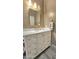 Bathroom vanity with white marble countertop, gold hardware, and modern light fixture at 10811 S 351St Ave, Arlington, AZ 85322