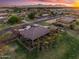 Aerial view of a home with a well-kept lawn, mature trees, and a large covered patio at 1096 W Via De Palmas --, San Tan Valley, AZ 85140