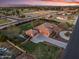 Aerial view showcasing the house, its circular driveway, well-maintained lawn, and surrounding landscaping at 1096 W Via De Palmas --, San Tan Valley, AZ 85140