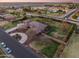 Scenic aerial view of a well-manicured property with mature trees and landscaping in a quiet neighborhood at 1096 W Via De Palmas --, San Tan Valley, AZ 85140
