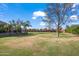 Vast backyard featuring mature trees, an expansive lawn, and picturesque landscaping, ideal for outdoor activities at 1096 W Via De Palmas --, San Tan Valley, AZ 85140